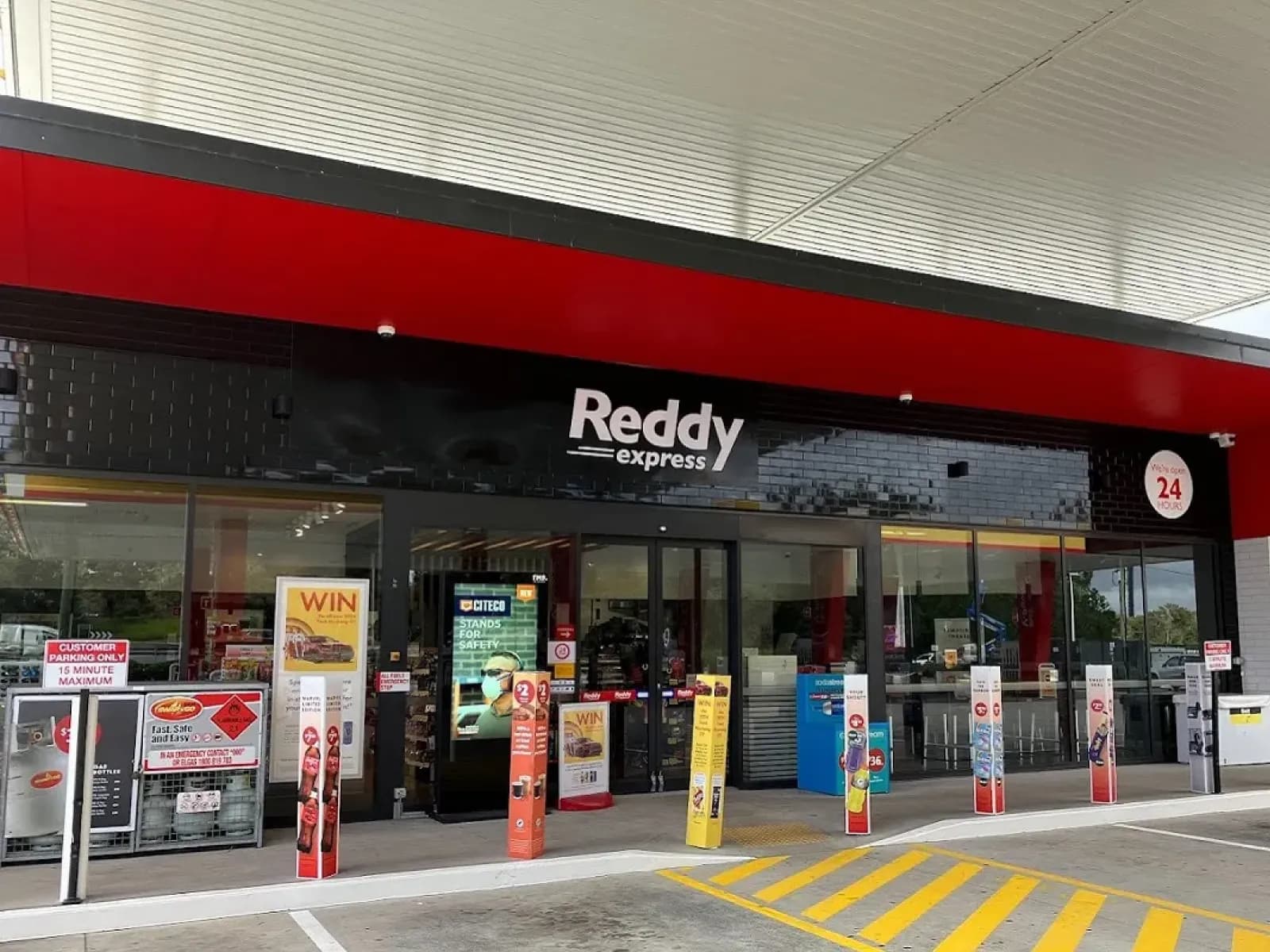 The entrance of a Reddy Express store under a Shell forecourt canopy
