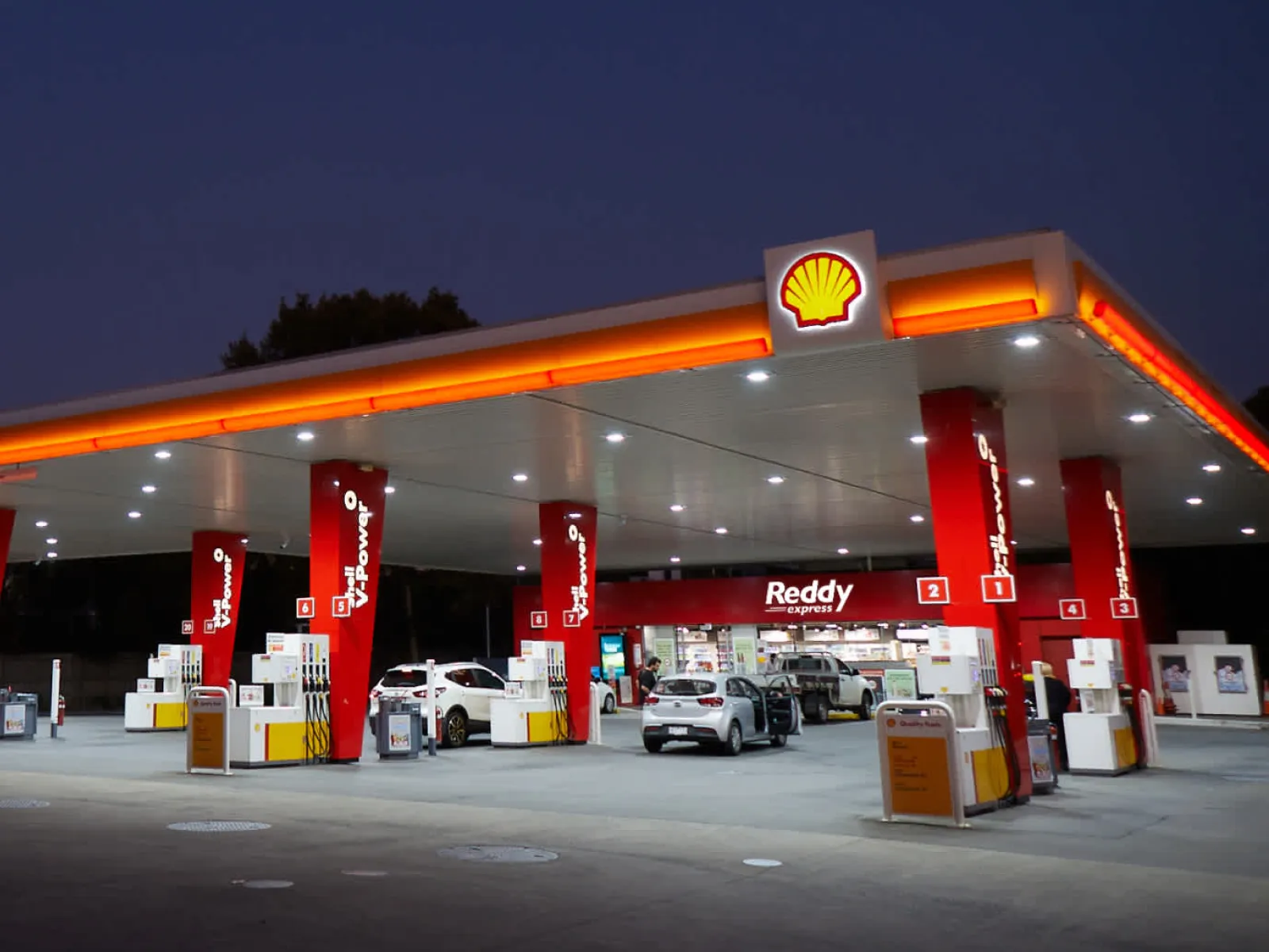 A Shell service station at dusk, with the Reddy Express store behind the pumps